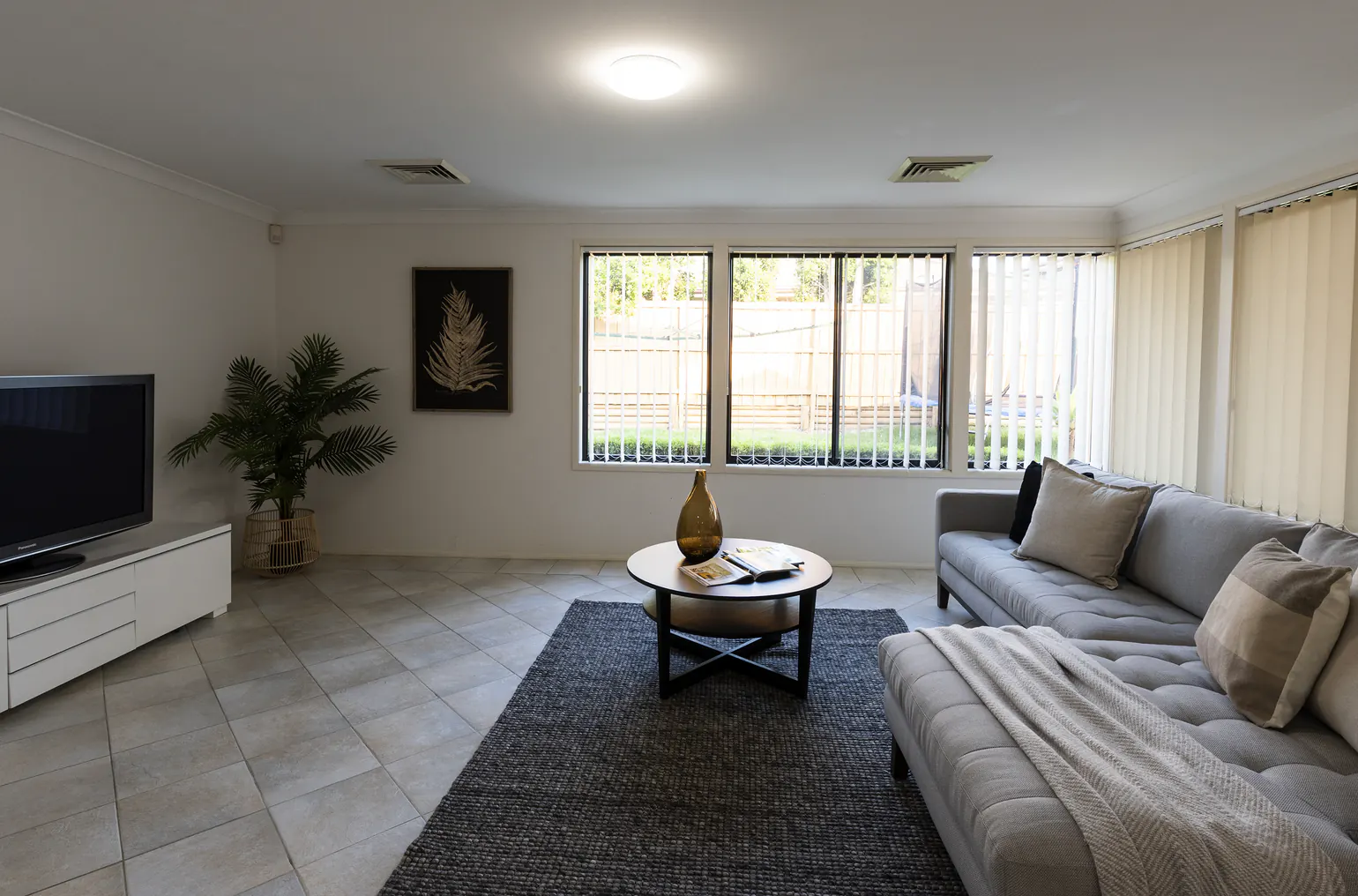 A dim living room with a blank TV